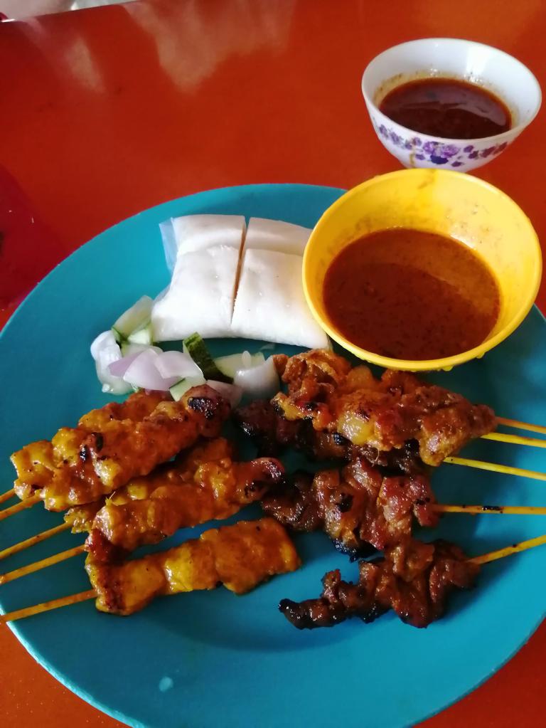 Satay (grilled meat on sticks), with peanut sauce and ketupat (rice cake)
